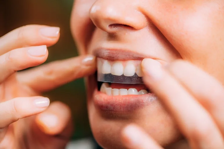 Woman Using Teeth Whitening Strip