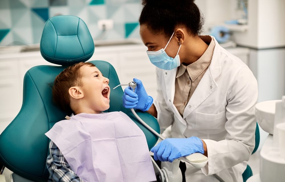 Photo of a Boy Having His Teeth Checked