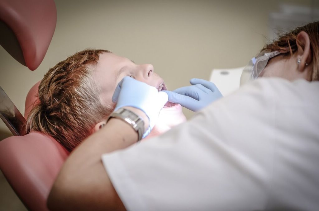 Child getting their teeth checked by a dentist