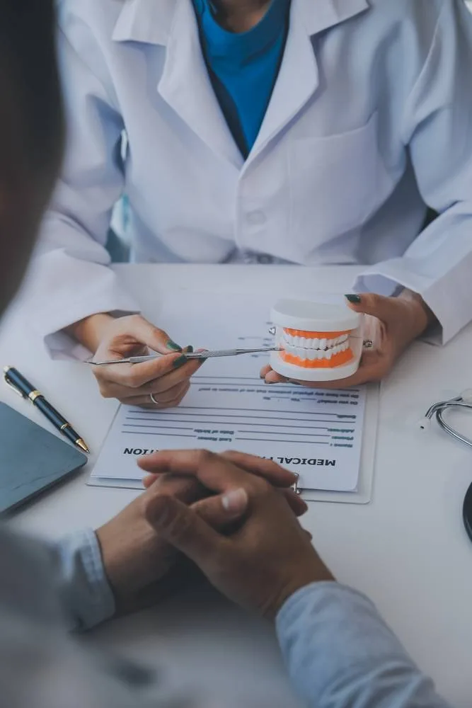Photo of dentist showing sample of teeth