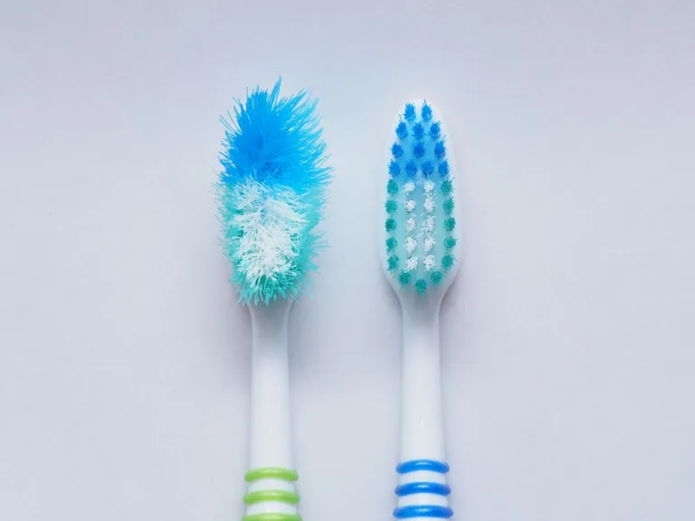 Comparison of the old and new toothbrushes in macro view, showing different bristle conditions: time to change a new toothbrush
